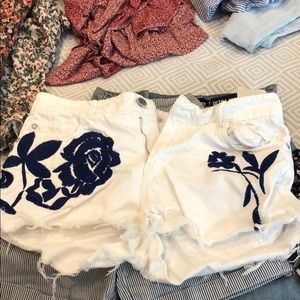 Blue embroidered flowers on white shorts